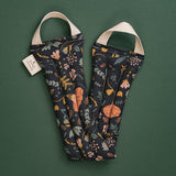 Slow North Hot + Cold Neck Wrap in Canyon Springs, a navy wrap with peach and blue florals, laid flat