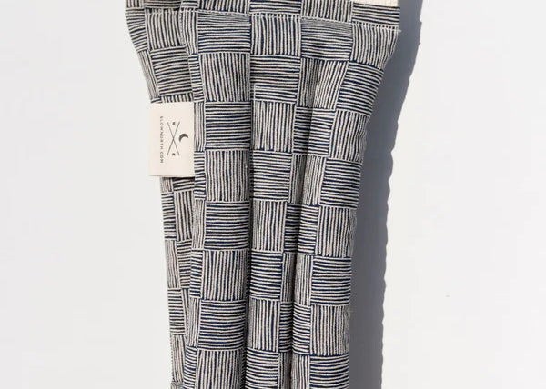 Slow North Hot + Cold Neck Wrap in Haystack, a navy and cream crosshatch print wrap, laid flat