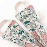 Slow North Hot + Cold Neck Wrap in Hidden Falls, a cream wrap with pink and green florals, laid flat