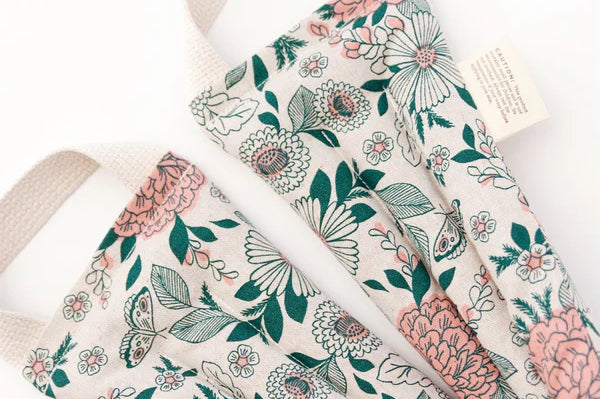 Slow North Hot + Cold Neck Wrap in Hidden Falls, a cream wrap with pink and green florals, laid flat