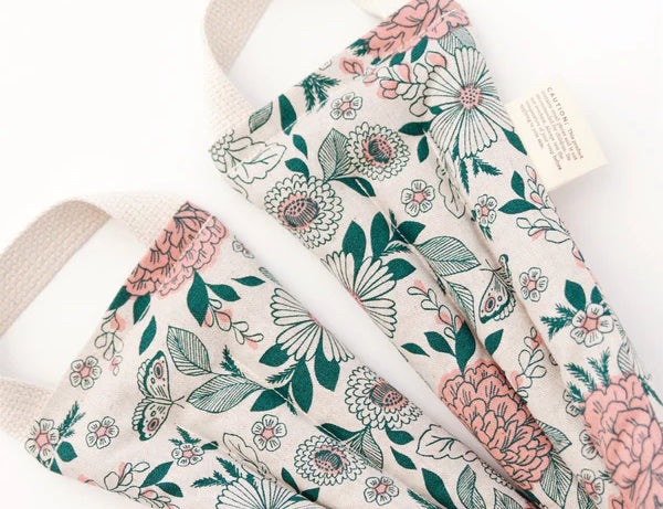 Slow North Hot + Cold Neck Wrap in Hidden Falls, a cream wrap with pink and green florals, laid flat