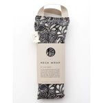 Slow North Hot + Cold Neck Wrap in Mystical Mushroom, a black and cream mushroom print wrap with a kraft sleeve