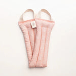 Slow North Hot + Cold Neck Wrap in Pink Pampas, a soft pink textured wrap, laid flat