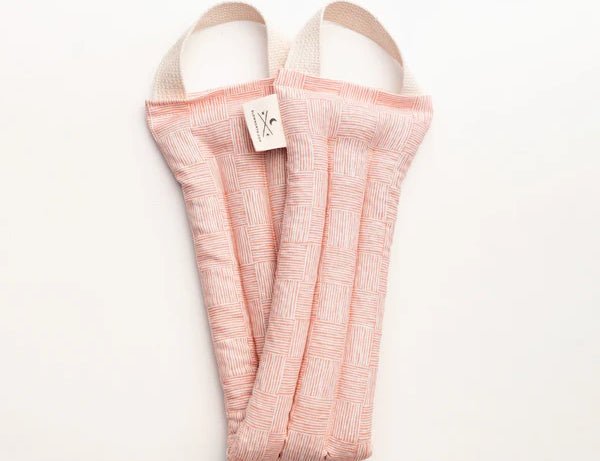 Slow North Hot + Cold Neck Wrap in Pink Pampas, a soft pink textured wrap, laid flat