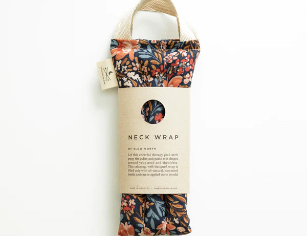 Slow North Hot + Cold Neck Wrap in Pom Blossom, a navy floral wrap with a kraft Neck Wrap sleeve