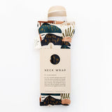 Slow North Hot + Cold Neck Wrap in Rainbow Hill, an abstract navy and rust landscape print with a kraft sleeve