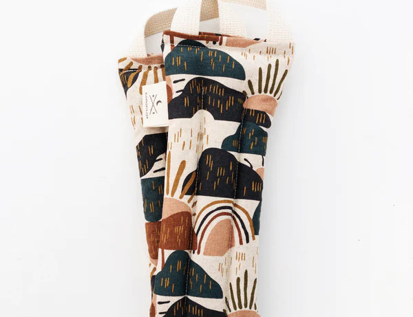 Slow North Hot + Cold Neck Wrap in Rainbow Hill, an abstract navy, rust and cream print, laid flat