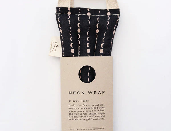 Slow North Hot + Cold Neck Wrap in Solstice, a black wrap with cream moon phases and a kraft sleeve