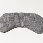 Slow North Migraine Mask in Haystack, a navy and cream crosshatch print eye mask, laid flat