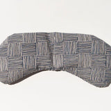 Slow North Migraine Mask in Haystack, a navy and cream crosshatch print eye mask, laid flat
