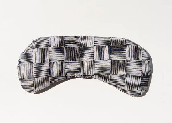 Slow North Migraine Mask in Haystack, a navy and cream crosshatch print eye mask, laid flat