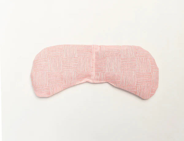 Slow North Migraine Mask in Pink Pampas, a soft pink textured eye mask, laid flat