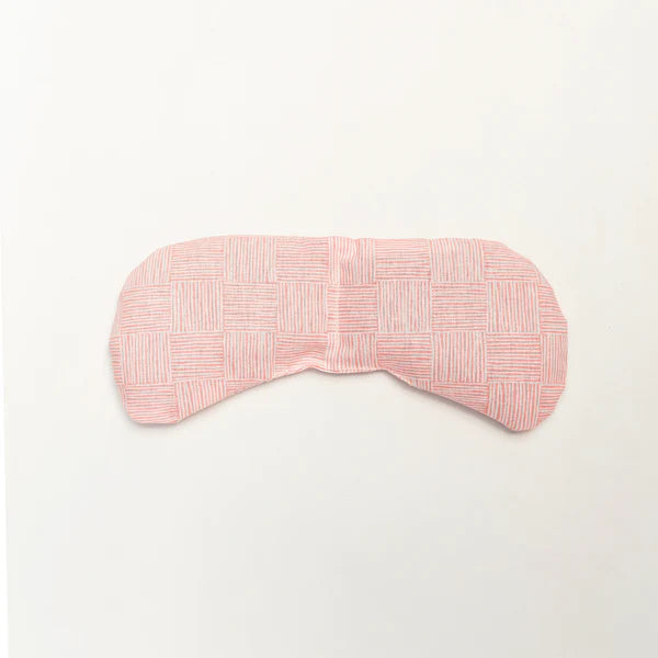 Slow North Migraine Mask in Pink Pampas, a soft pink textured eye mask, laid flat