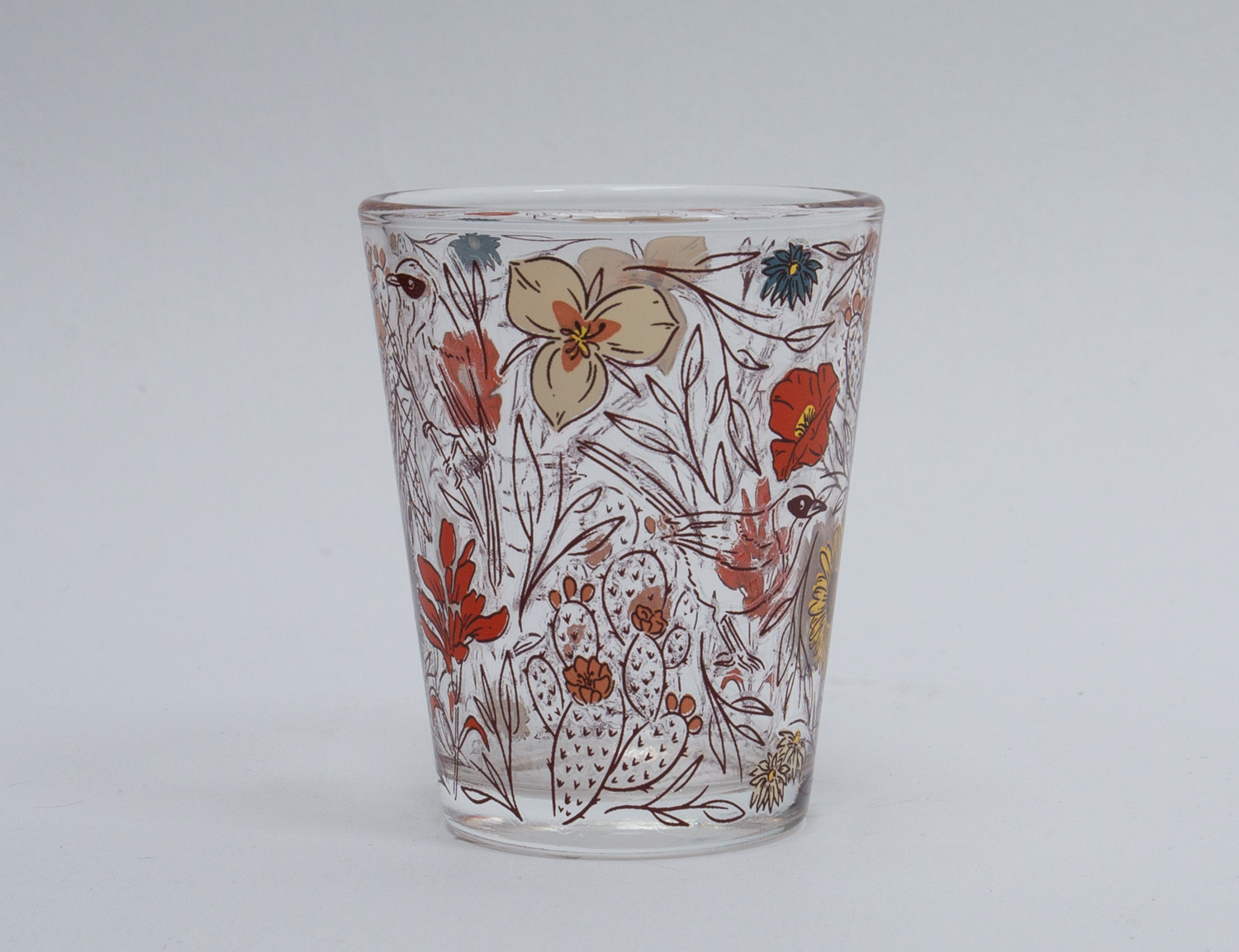 Clear Moab shot glass illustrated with desert wildflowers, cacti and a songbird