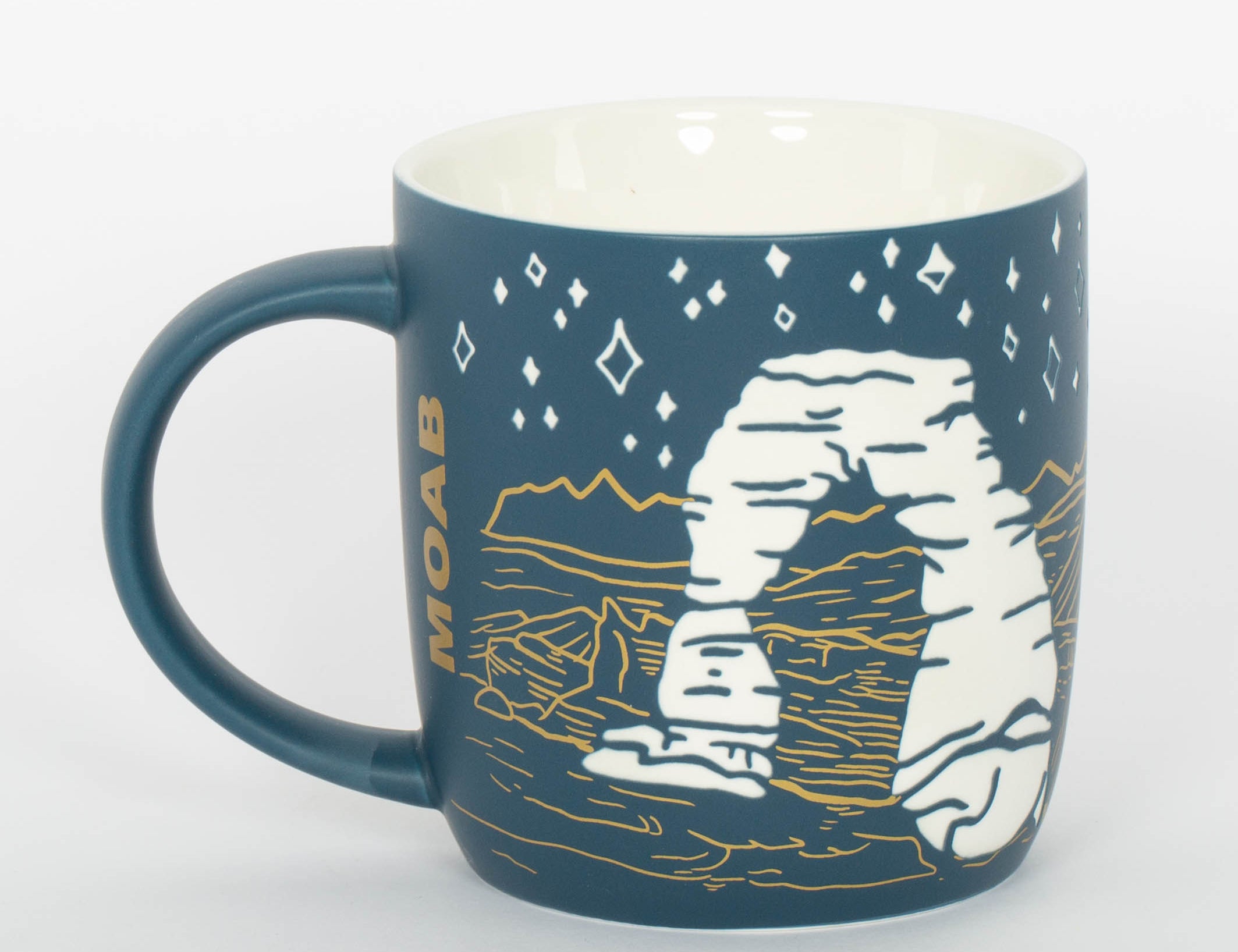 Etched ceramic Moab mug with Delicate Arch on a deep blue night sky