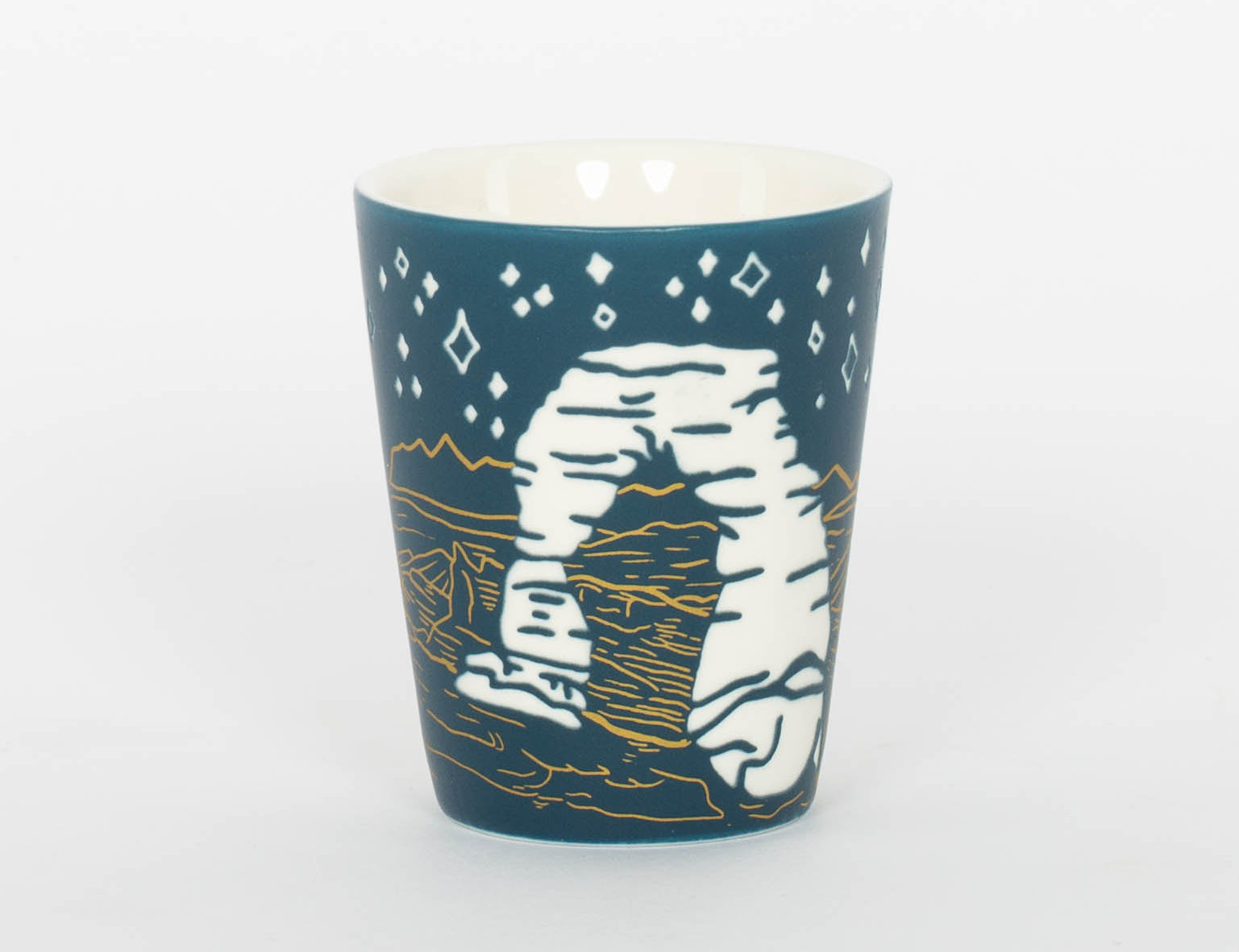 Deep blue etched Moab shot glass with Delicate Arch under a starry sky
