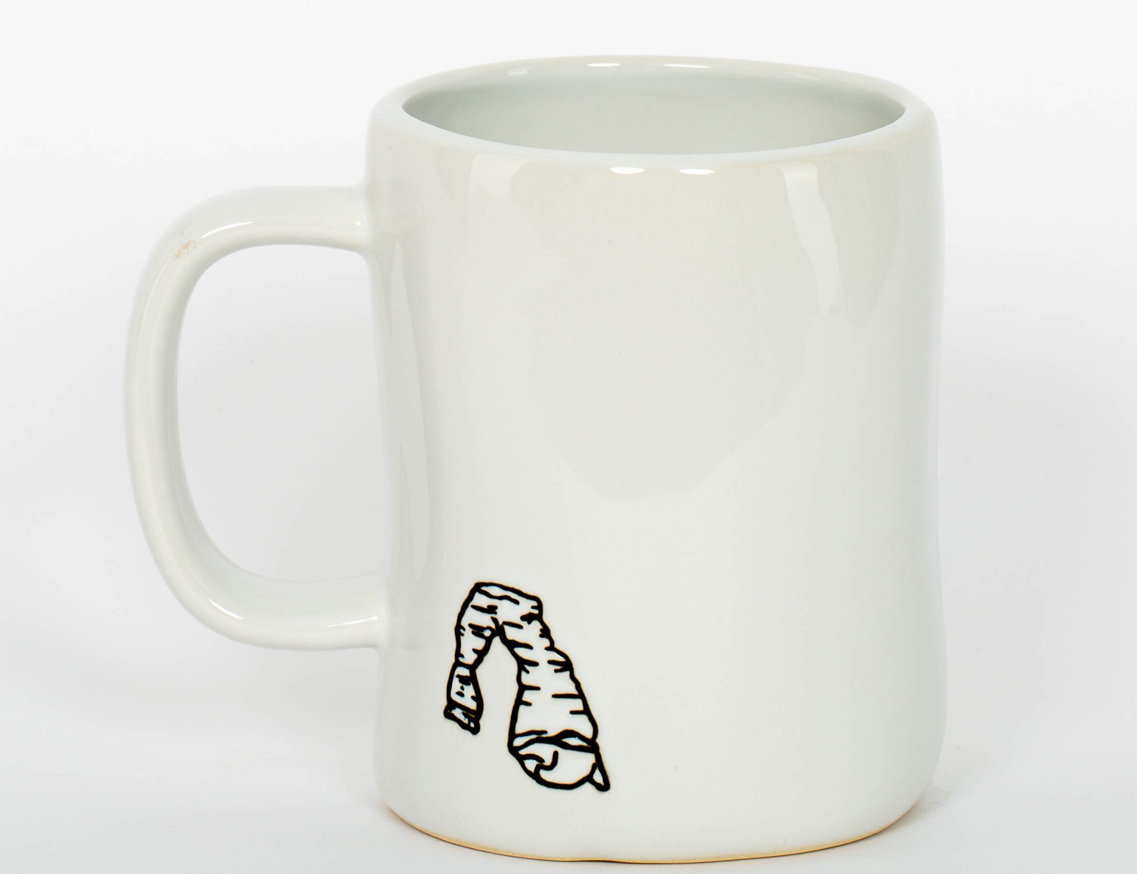 White ceramic Moab mug with a hand drawn arch and bold lettering, second view