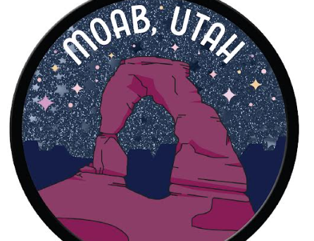 Round glitter Moab magnet with Delicate Arch in rose on a navy sky, lettered Moab Utah