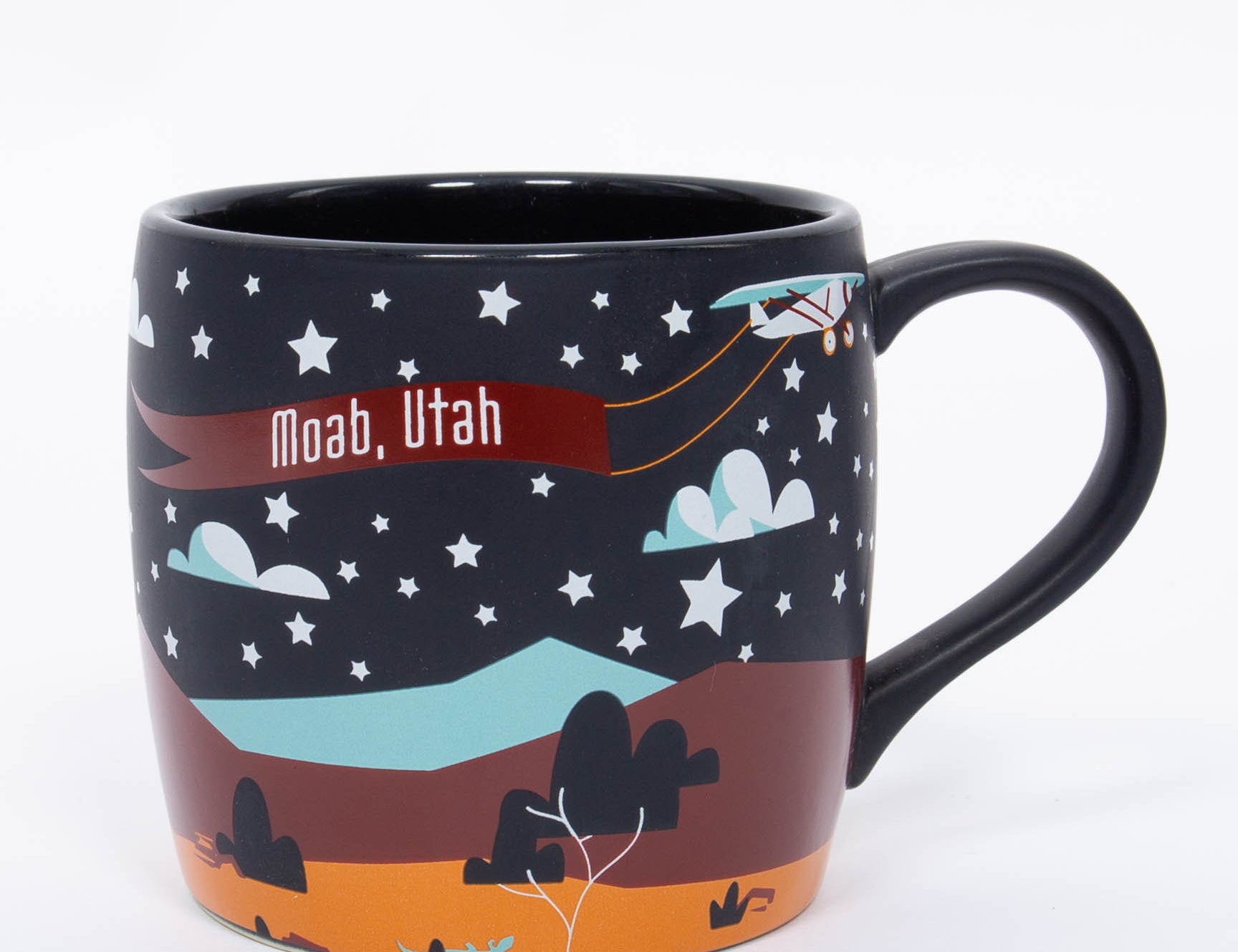 Navy ceramic Moab mug with a crescent moon, stars and layered orange red rock, second view