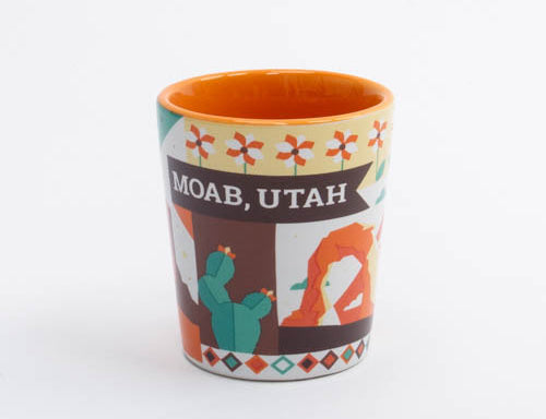 Ceramic Moab shot glass with a red rock landscape and cactus silhouettes, second view