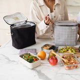 SoYoung Lunch Poche in black open on a marble table with packed lunch containers and fruit