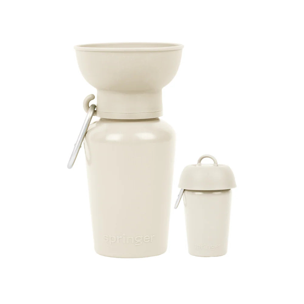 Springer 20 oz Dog Travel Water Bottle in Oat, a cream flip bottle with a collapsible silicone bowl