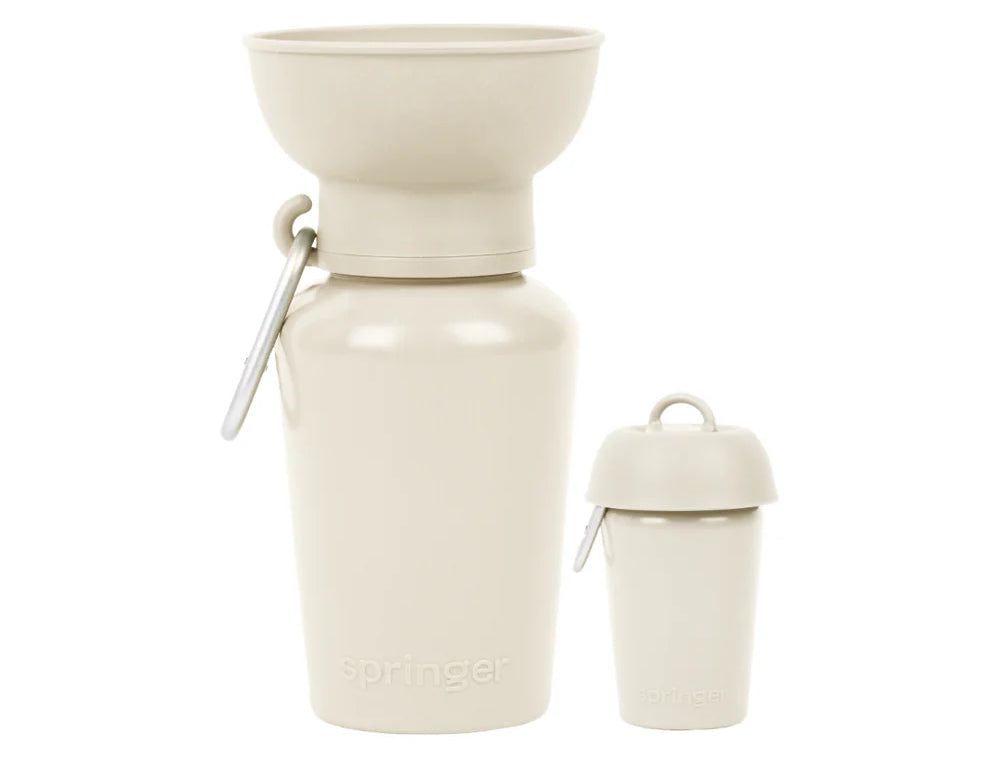 Springer 20 oz Dog Travel Water Bottle in Oat, a cream flip bottle with a collapsible silicone bowl