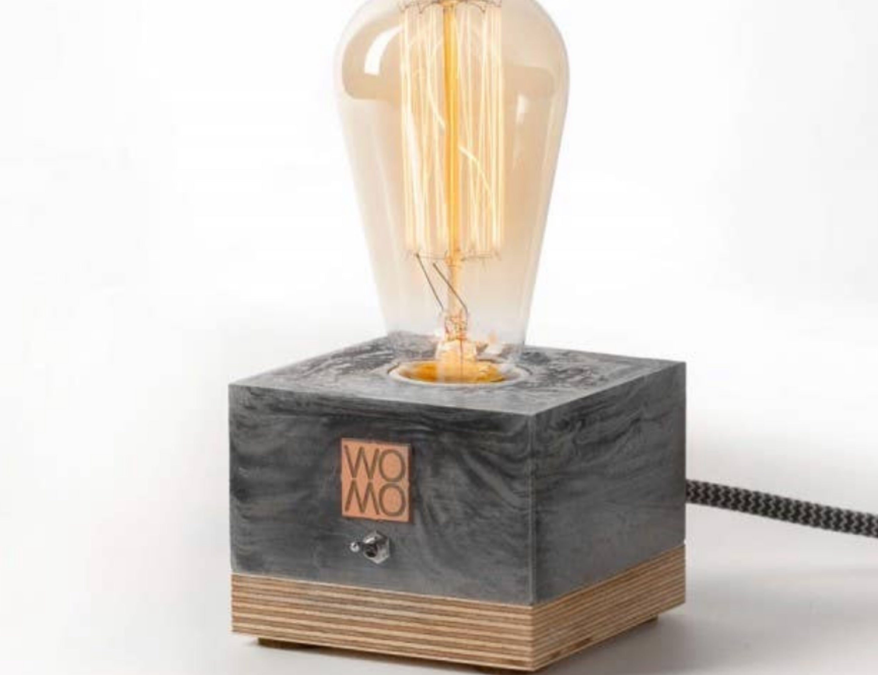 Studio Bylamp Table Lamp, a black concrete and wood block base with an exposed Edison bulb