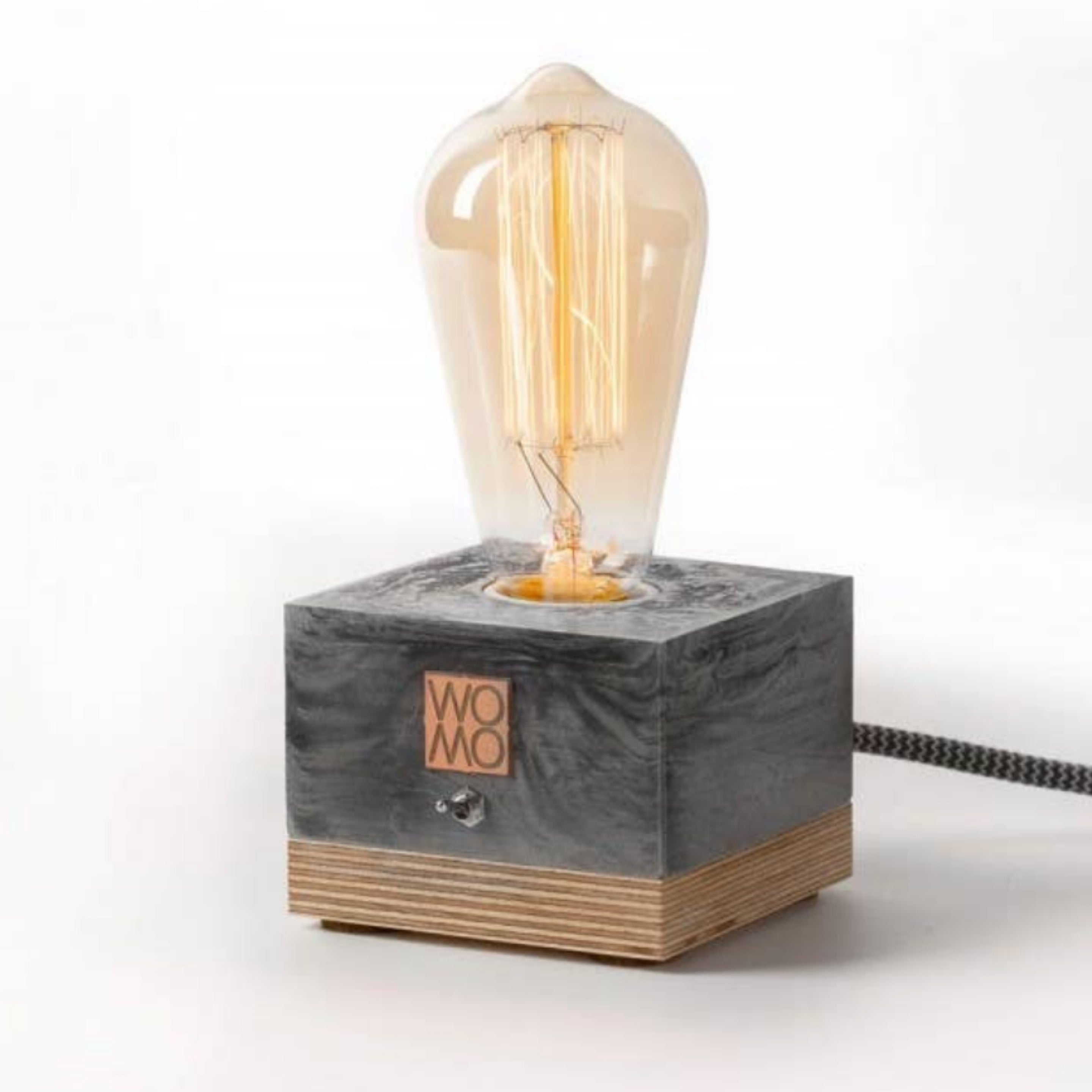 Studio Bylamp Table Lamp, a black concrete and wood block base with an exposed Edison bulb