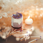 Tenn Prairie Concrete Match Holder in acai and white with purple matches scattered beside a tealight