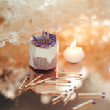 Tenn Prairie Concrete Match Holder in acai and white with purple matches scattered beside a tealight