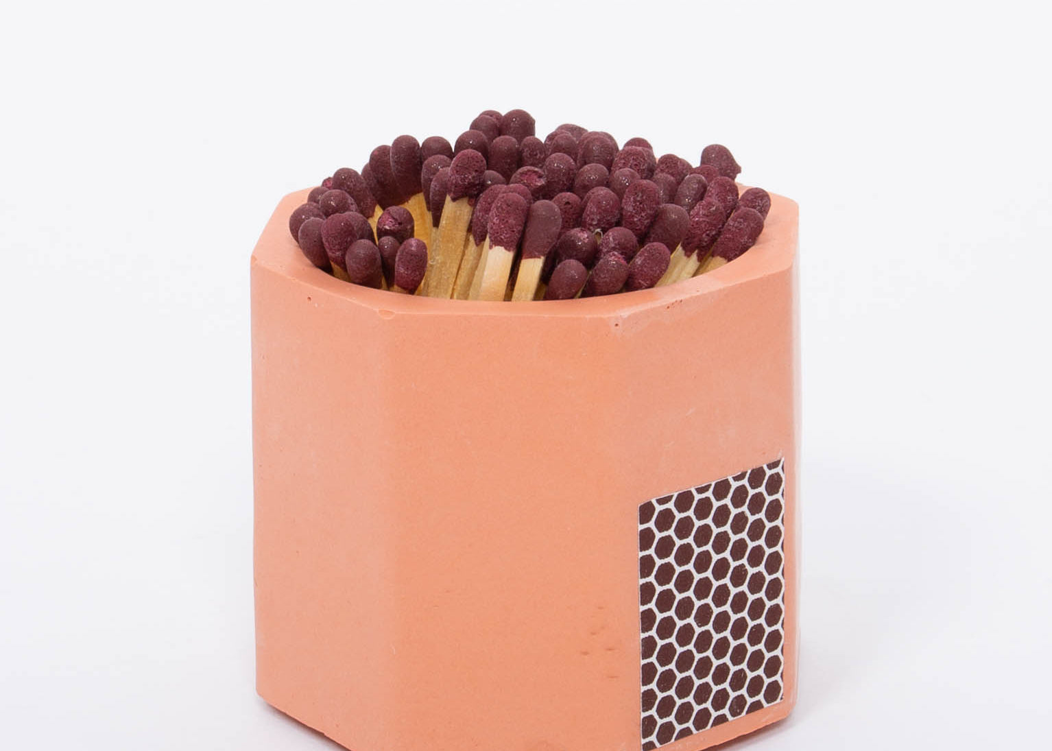 Tenn Prairie Concrete Match Holder in Brick orange with maroon-tipped matches and a side striker