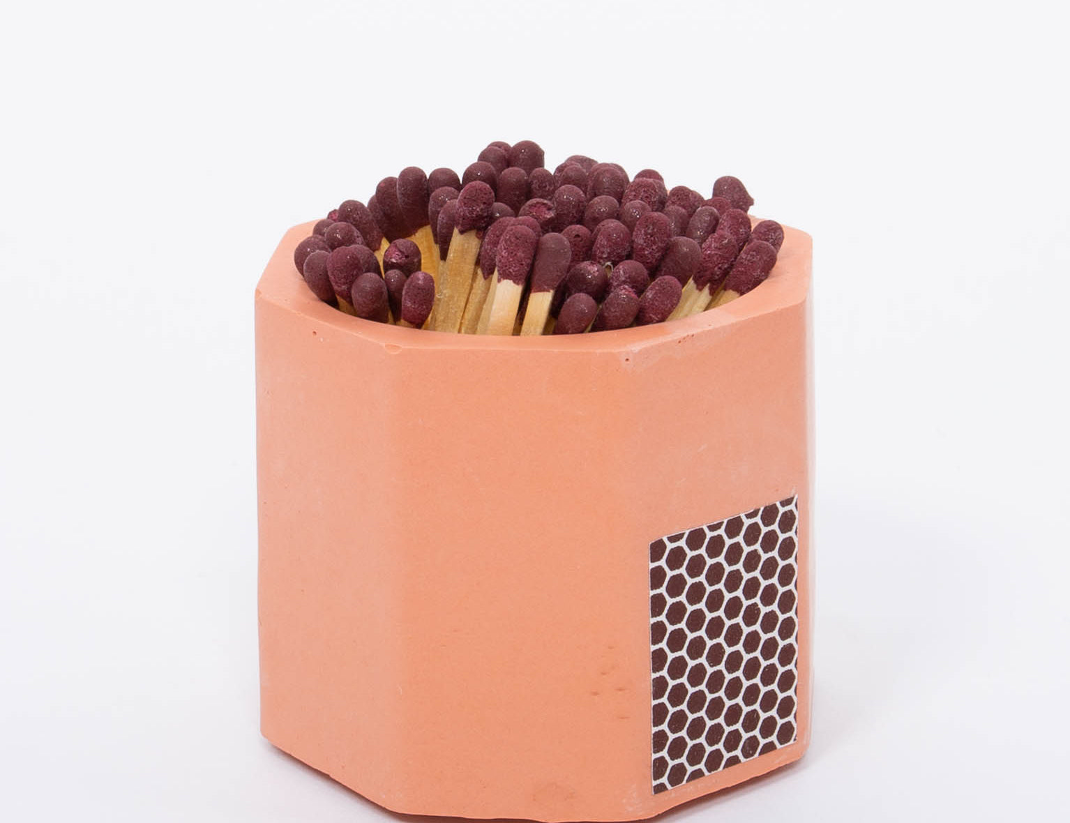 Tenn Prairie Concrete Match Holder in Brick orange with maroon-tipped matches and a side striker