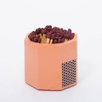 Tenn Prairie Concrete Match Holder in Brick orange with maroon-tipped matches and a side striker
