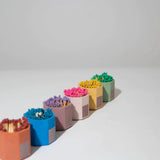 Row of Tenn Prairie Concrete Match Holders in assorted colors filled with colorful matches