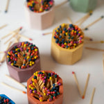 Tenn Prairie Concrete Match Holders in terracotta, peach, mustard and navy filled with rainbow matches