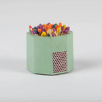 Tenn Prairie Concrete Match Holder in Matcha green with rainbow-tipped matches and a side striker