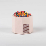 Tenn Prairie Concrete Match Holder in Pink with rainbow-tipped matches and a side striker