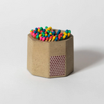 Tenn Prairie Concrete Match Holder in Taupe with rainbow-tipped matches and a side striker