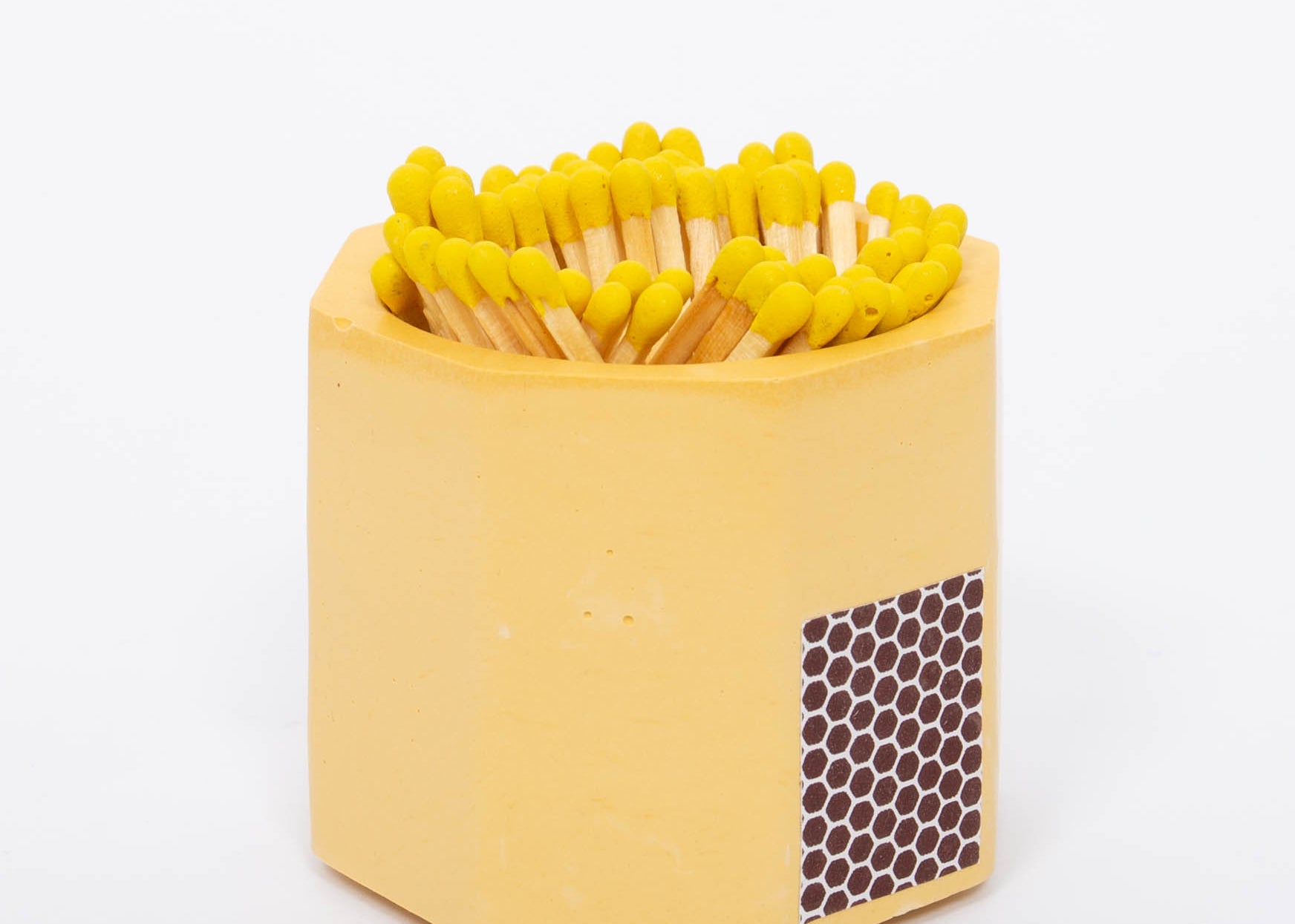 Tenn Prairie Concrete Match Holder in Yellow with yellow-tipped matches and a side striker