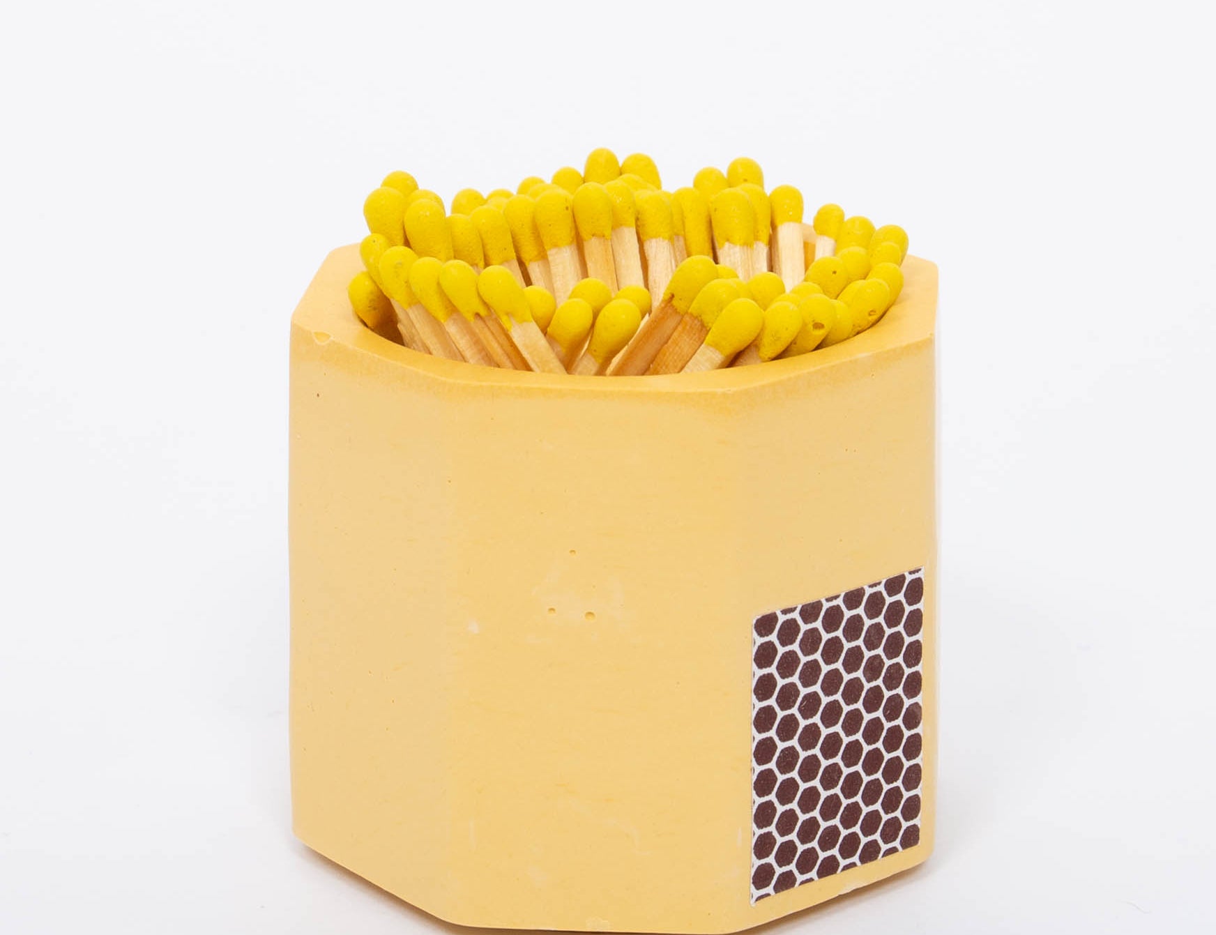 Tenn Prairie Concrete Match Holder in Yellow with yellow-tipped matches and a side striker