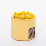 Tenn Prairie Concrete Match Holder in Yellow with yellow-tipped matches and a side striker