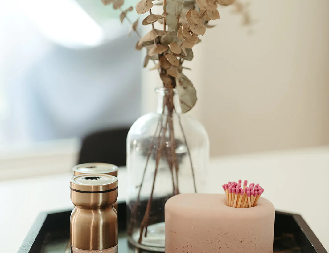 Tenn Prairie Streamliner Match Holder in Blush on a black tray with eucalyptus and a candle