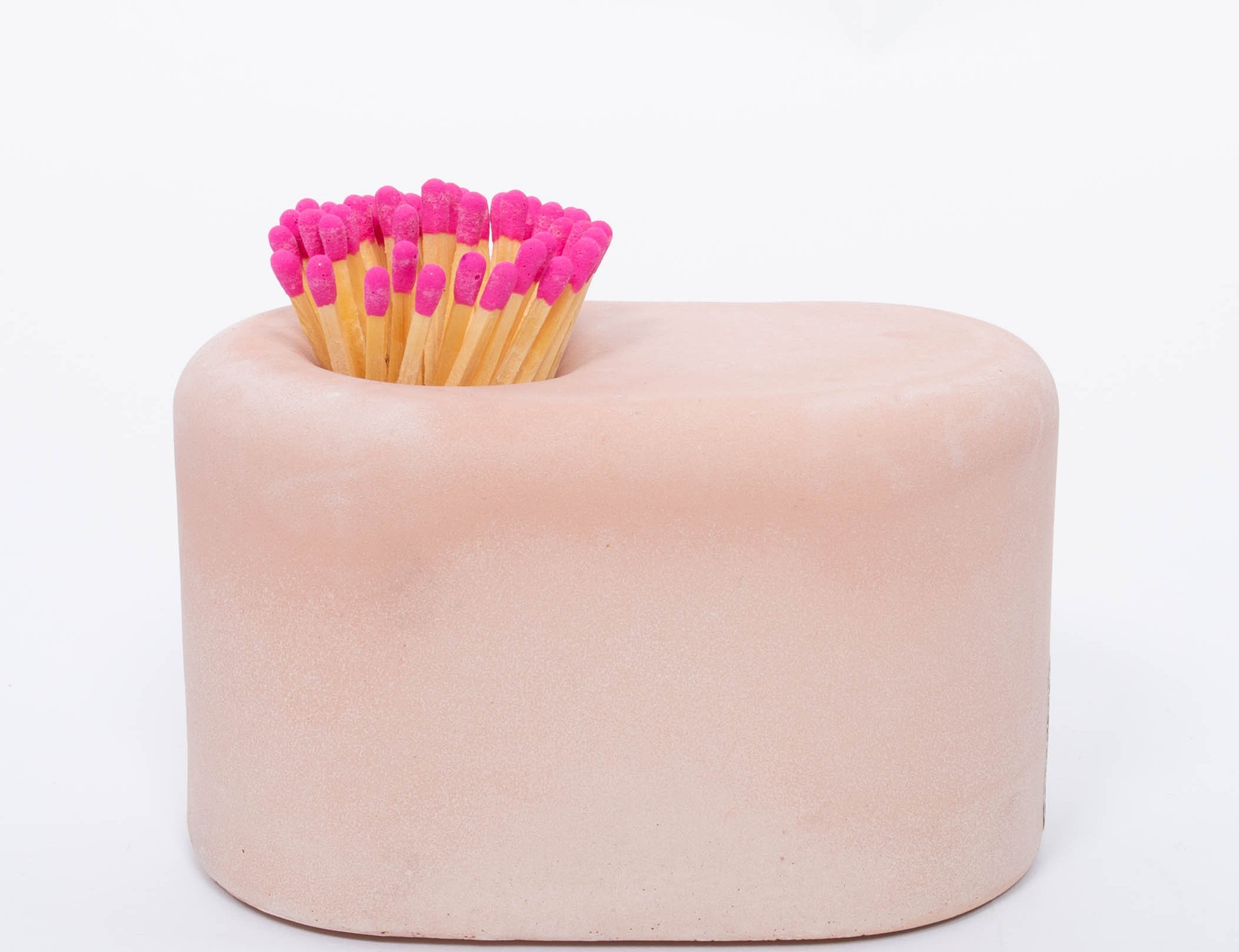 Tenn Prairie Streamliner Match Holder in Blush, a rounded pink concrete holder with pink-tipped matches