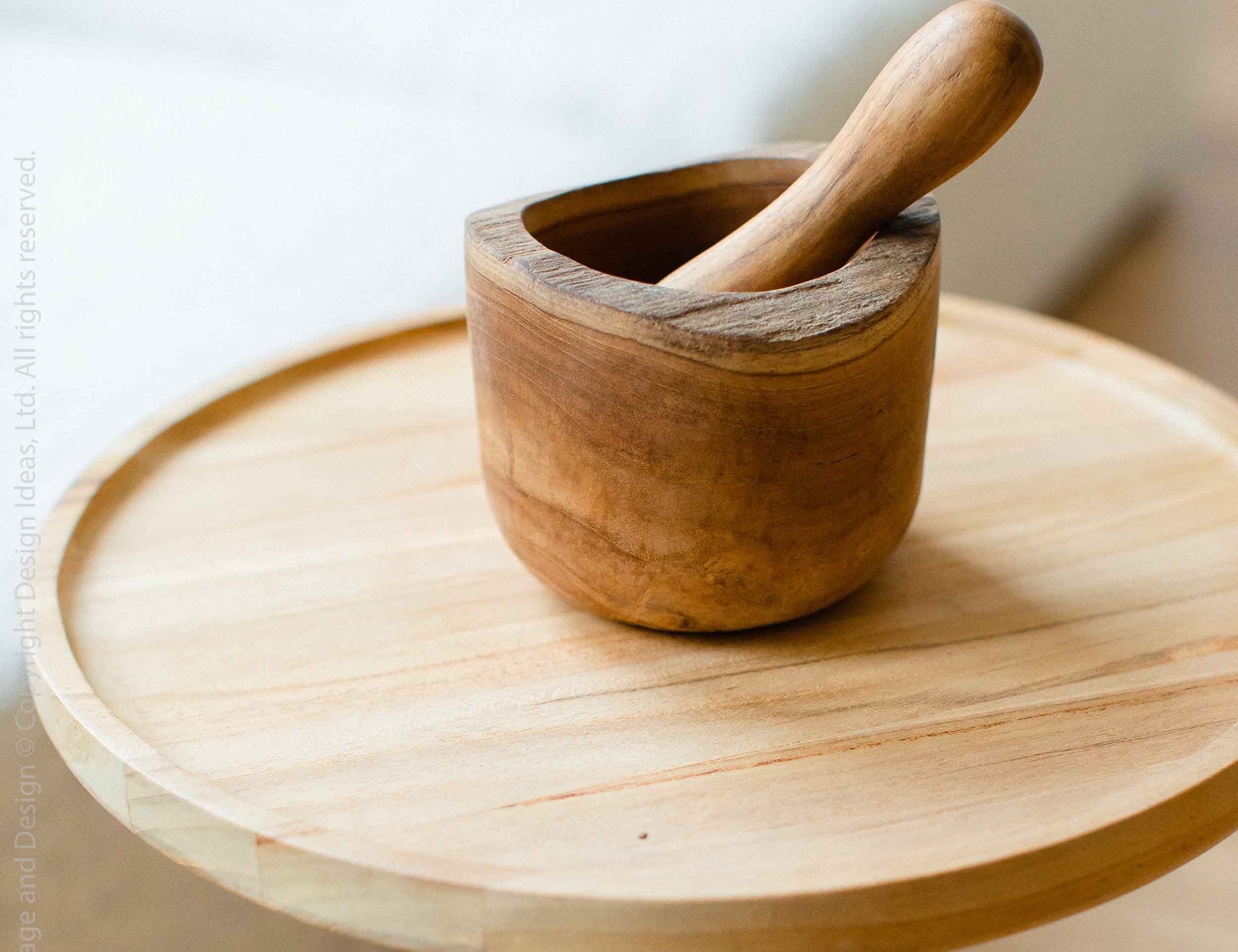 Texxture Takara Teak Root Mortar & Pestle on a round wooden stool