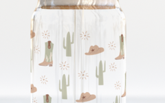 The Care Co Cowboy Desert Glass Can with a bamboo lid and glass straw, printed with cacti, boots and hats