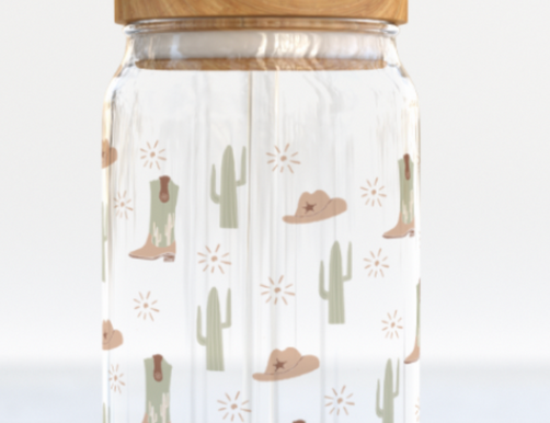 The Care Co Cowboy Desert Glass Can with a bamboo lid and glass straw, printed with cacti, boots and hats
