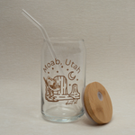 The Care Co Moab Desert Glass Can with the bamboo lid resting beside it and a glass straw