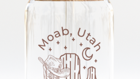 The Care Co Moab Desert Glass Can with a bamboo lid and glass straw, printed with a cowboy hat and desert buttes