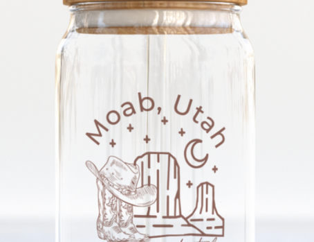 The Care Co Moab Desert Glass Can with a bamboo lid and glass straw, printed with a cowboy hat and desert buttes
